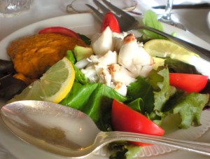The Avocate Frise - Fresh crab meat served over greens, tomato, fresh avocado with a delicate red pepper cream